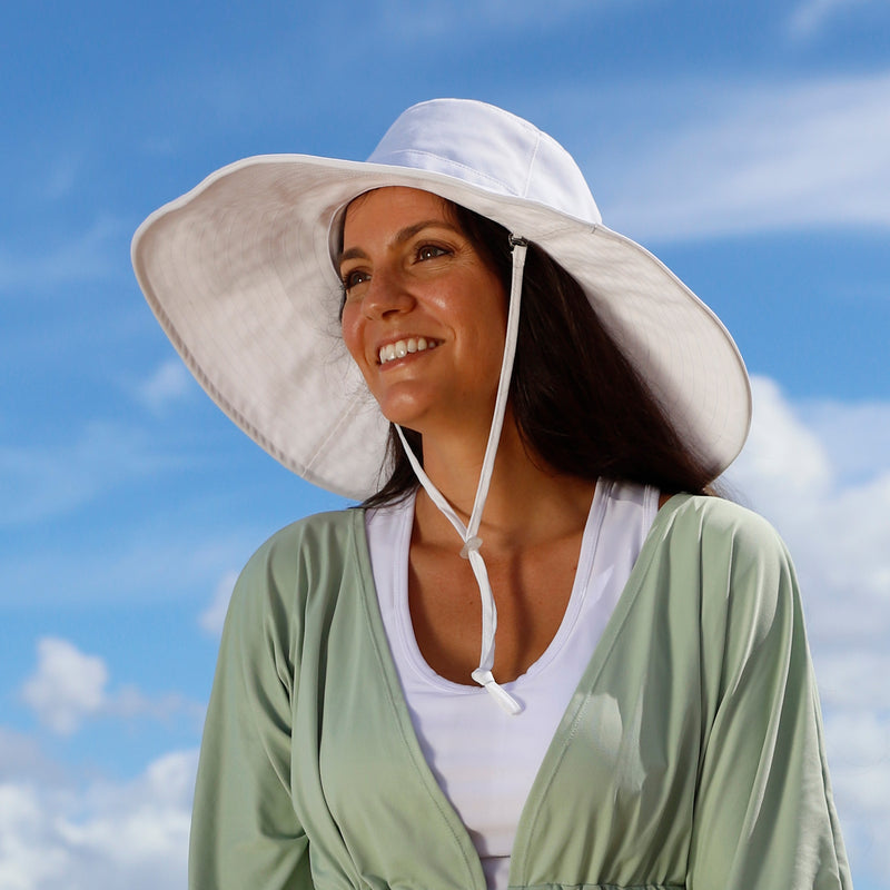 woman in women's max shade hat in white|white