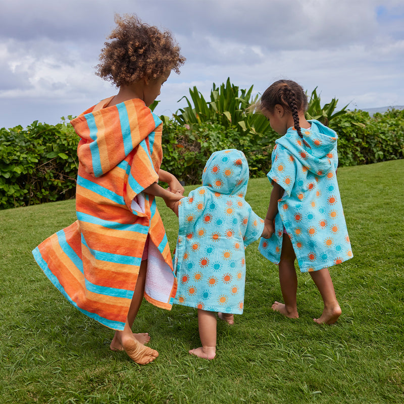 kids running away in hooded beach poncho|sunset-stripe