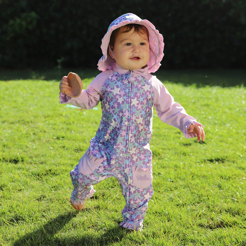 baby girl running in grass in sun & swim suit in lotus starfish|lotus-starfish